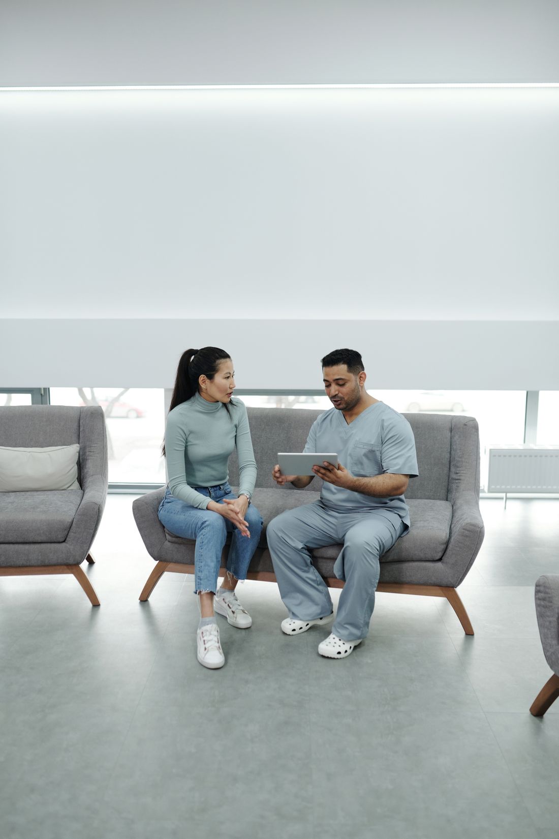Medical practitioner using a tablet during a patient consultation