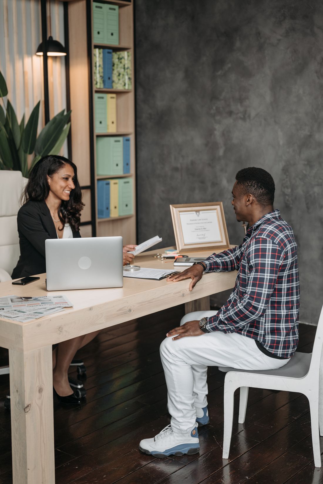 Legal professional consulting with a client in an office