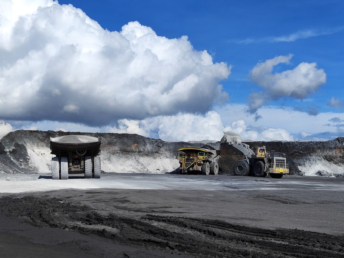 Open pit mining operation with heavy machinery